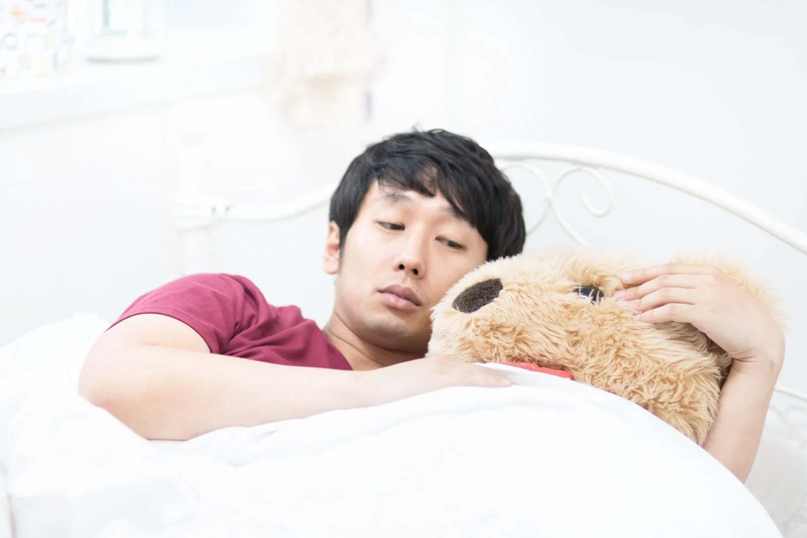 夜中に目が覚めて眠れず悩む男性のイメージ